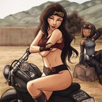 Девушка в коротком топике сидит на мотоцикле