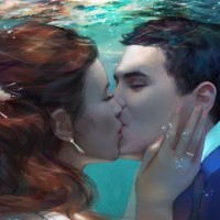 Парень с девушкой целуются под водой.
